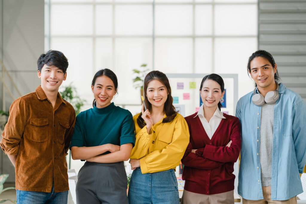 group of asia young creative people in smart casual wear smiling